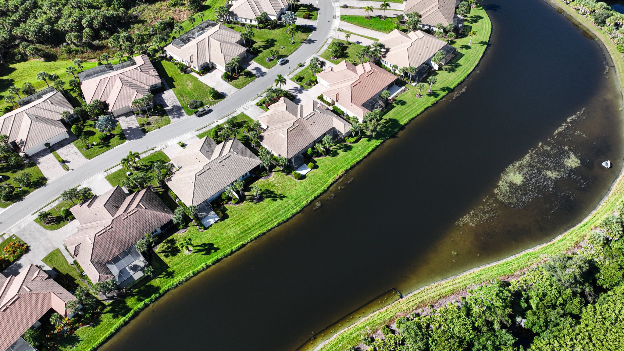 Drone aerial photo of waterfront homes along a canal community